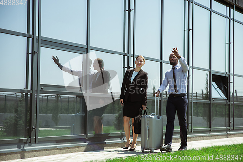 Image of Meeting of young business partners after arriving to end point of business trip