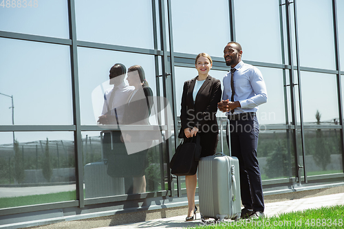 Image of Meeting of young business partners after arriving to end point of business trip