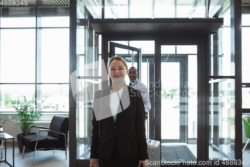 Image of Meeting of young business partners after arriving to end point of business trip