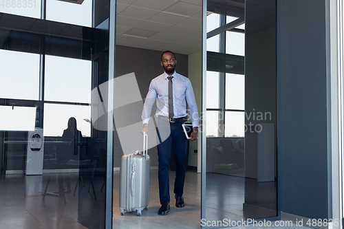 Image of Young businessman after departure in airport, work trip, business lifestyle