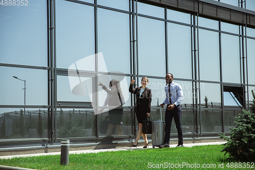 Image of Meeting of young business partners after arriving to end point of business trip