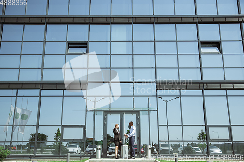 Image of Meeting of young business partners after arriving to end point of business trip