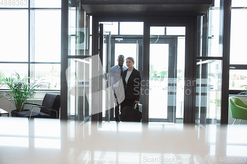 Image of Meeting of young business partners after arriving to end point of business trip