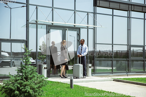 Image of Meeting of young business partners after arriving to end point of business trip