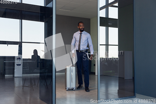 Image of Young businessman after departure in airport, work trip, business lifestyle