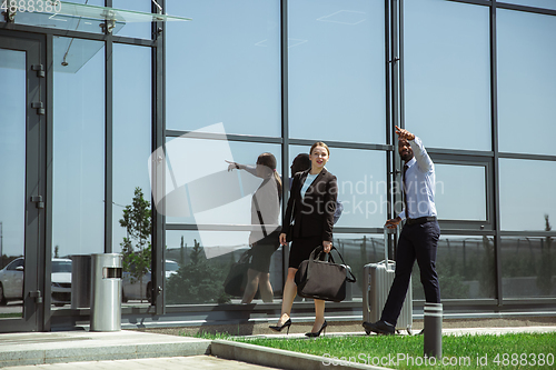 Image of Meeting of young business partners after arriving to end point of business trip