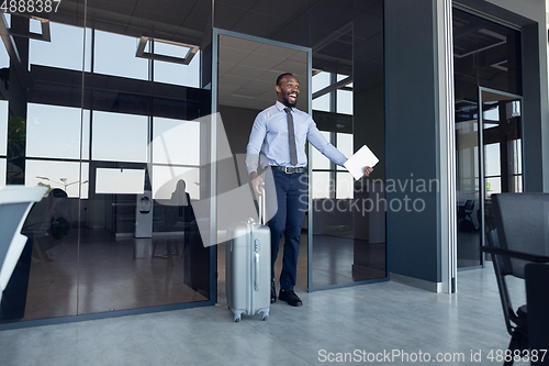 Image of Young businessman after departure in airport, work trip, business lifestyle