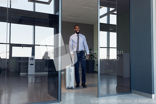 Image of Young businessman after departure in airport, work trip, business lifestyle