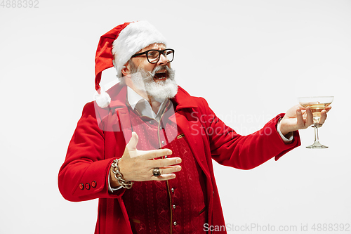 Image of Modern stylish Santa Claus in red fashionable suit isolated on white background