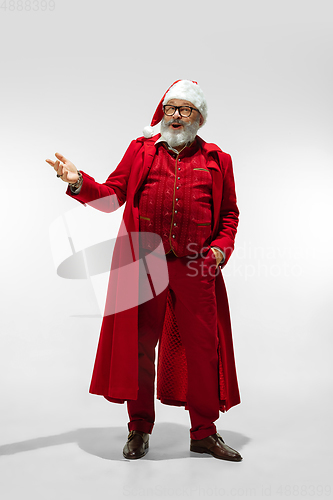 Image of Modern stylish Santa Claus in red fashionable suit isolated on white background