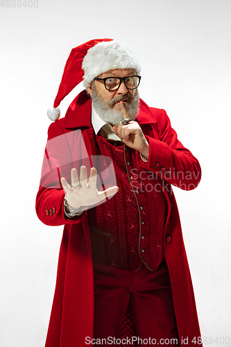 Image of Modern stylish Santa Claus in red fashionable suit isolated on white background