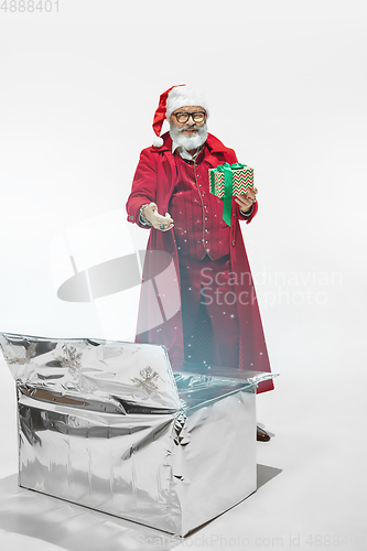 Image of Modern stylish Santa Claus in red fashionable suit isolated on white background