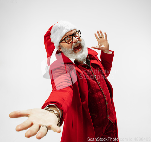 Image of Modern stylish Santa Claus in red fashionable suit isolated on white background