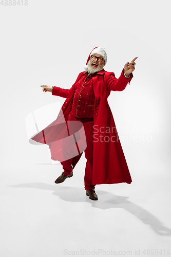 Image of Modern stylish Santa Claus in red fashionable suit isolated on white background