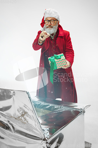 Image of Modern stylish Santa Claus in red fashionable suit isolated on white background