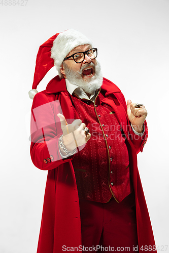 Image of Modern stylish Santa Claus in red fashionable suit isolated on white background