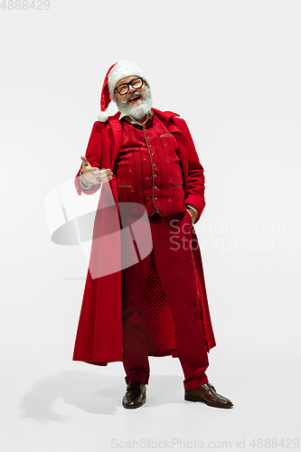 Image of Modern stylish Santa Claus in red fashionable suit isolated on white background