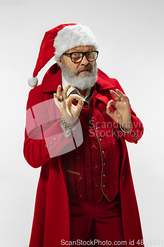 Image of Modern stylish Santa Claus in red fashionable suit isolated on white background