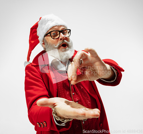 Image of Modern stylish Santa Claus in red fashionable suit isolated on white background