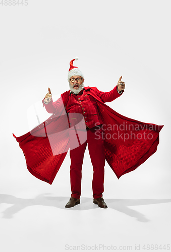 Image of Modern stylish Santa Claus in red fashionable suit isolated on white background