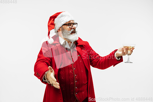 Image of Modern stylish Santa Claus in red fashionable suit isolated on white background