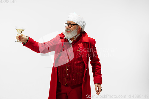 Image of Modern stylish Santa Claus in red fashionable suit isolated on white background