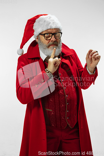 Image of Modern stylish Santa Claus in red fashionable suit isolated on white background