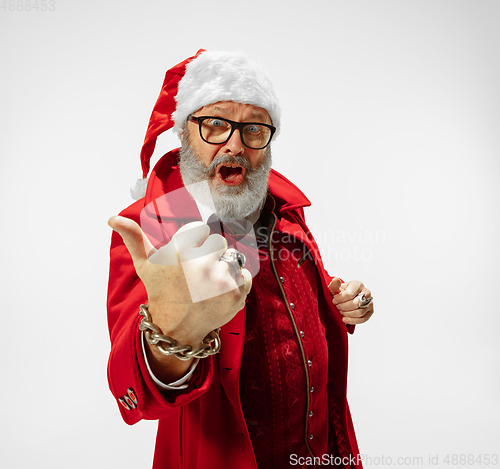 Image of Modern stylish Santa Claus in red fashionable suit isolated on white background