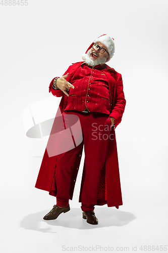 Image of Modern stylish Santa Claus in red fashionable suit isolated on white background