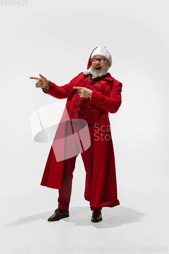 Image of Modern stylish Santa Claus in red fashionable suit isolated on white background