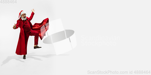 Image of Modern stylish Santa Claus in red fashionable suit isolated on white background