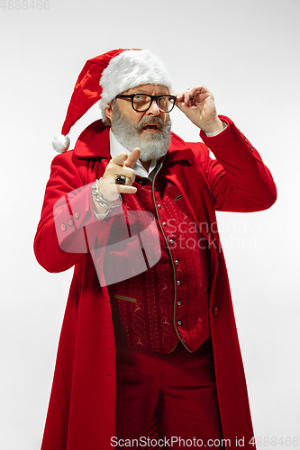 Image of Modern stylish Santa Claus in red fashionable suit isolated on white background