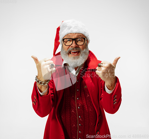 Image of Modern stylish Santa Claus in red fashionable suit isolated on white background