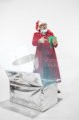 Image of Modern stylish Santa Claus in red fashionable suit isolated on white background