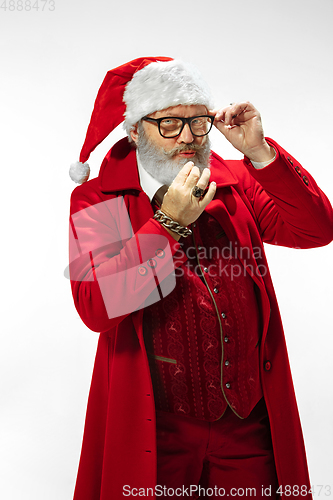 Image of Modern stylish Santa Claus in red fashionable suit isolated on white background