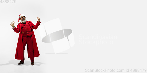 Image of Modern stylish Santa Claus in red fashionable suit isolated on white background