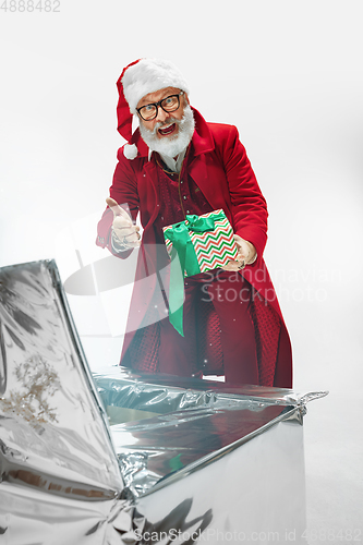 Image of Modern stylish Santa Claus in red fashionable suit isolated on white background