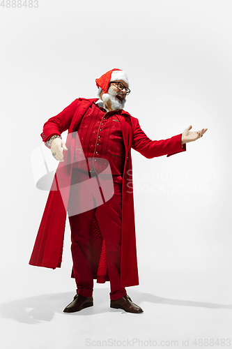 Image of Modern stylish Santa Claus in red fashionable suit isolated on white background