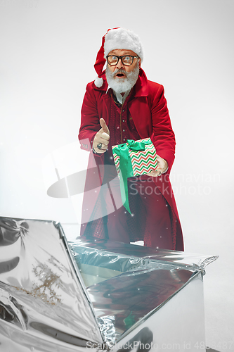 Image of Modern stylish Santa Claus in red fashionable suit isolated on white background