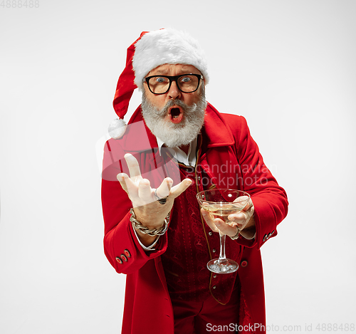 Image of Modern stylish Santa Claus in red fashionable suit isolated on white background