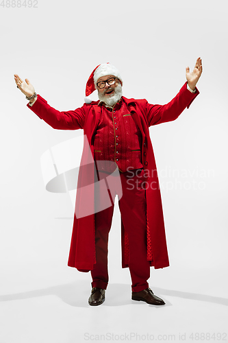 Image of Modern stylish Santa Claus in red fashionable suit isolated on white background