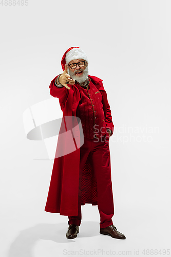 Image of Modern stylish Santa Claus in red fashionable suit isolated on white background