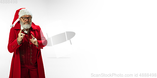 Image of Modern stylish Santa Claus in red fashionable suit isolated on white background