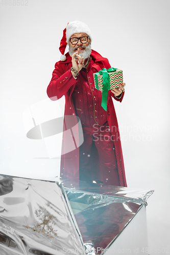 Image of Modern stylish Santa Claus in red fashionable suit isolated on white background