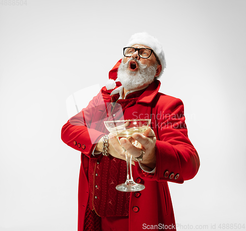 Image of Modern stylish Santa Claus in red fashionable suit isolated on white background