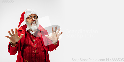 Image of Modern stylish Santa Claus in red fashionable suit isolated on white background