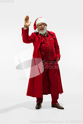 Image of Modern stylish Santa Claus in red fashionable suit isolated on white background