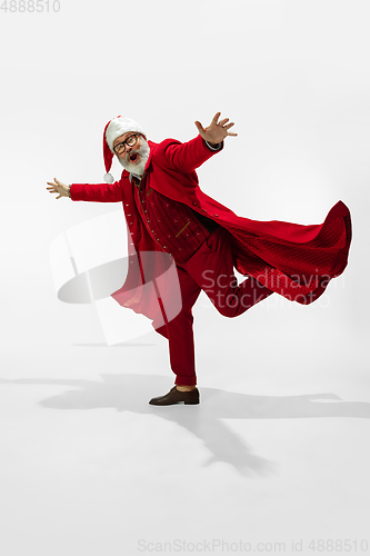 Image of Modern stylish Santa Claus in red fashionable suit isolated on white background