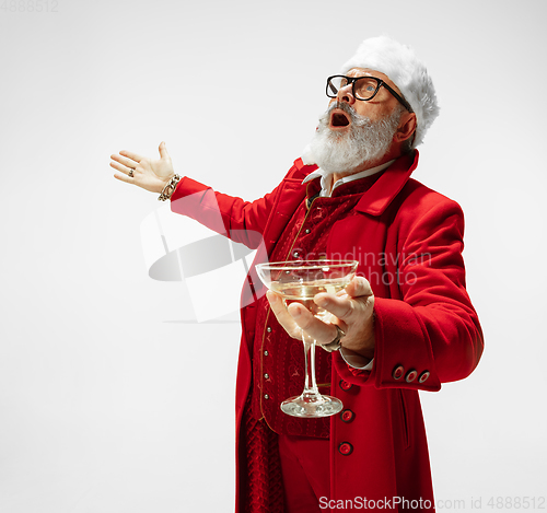 Image of Modern stylish Santa Claus in red fashionable suit isolated on white background