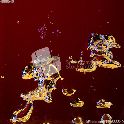 Image of Close up view of the cold and fresh cola with bright bubbles in neon light